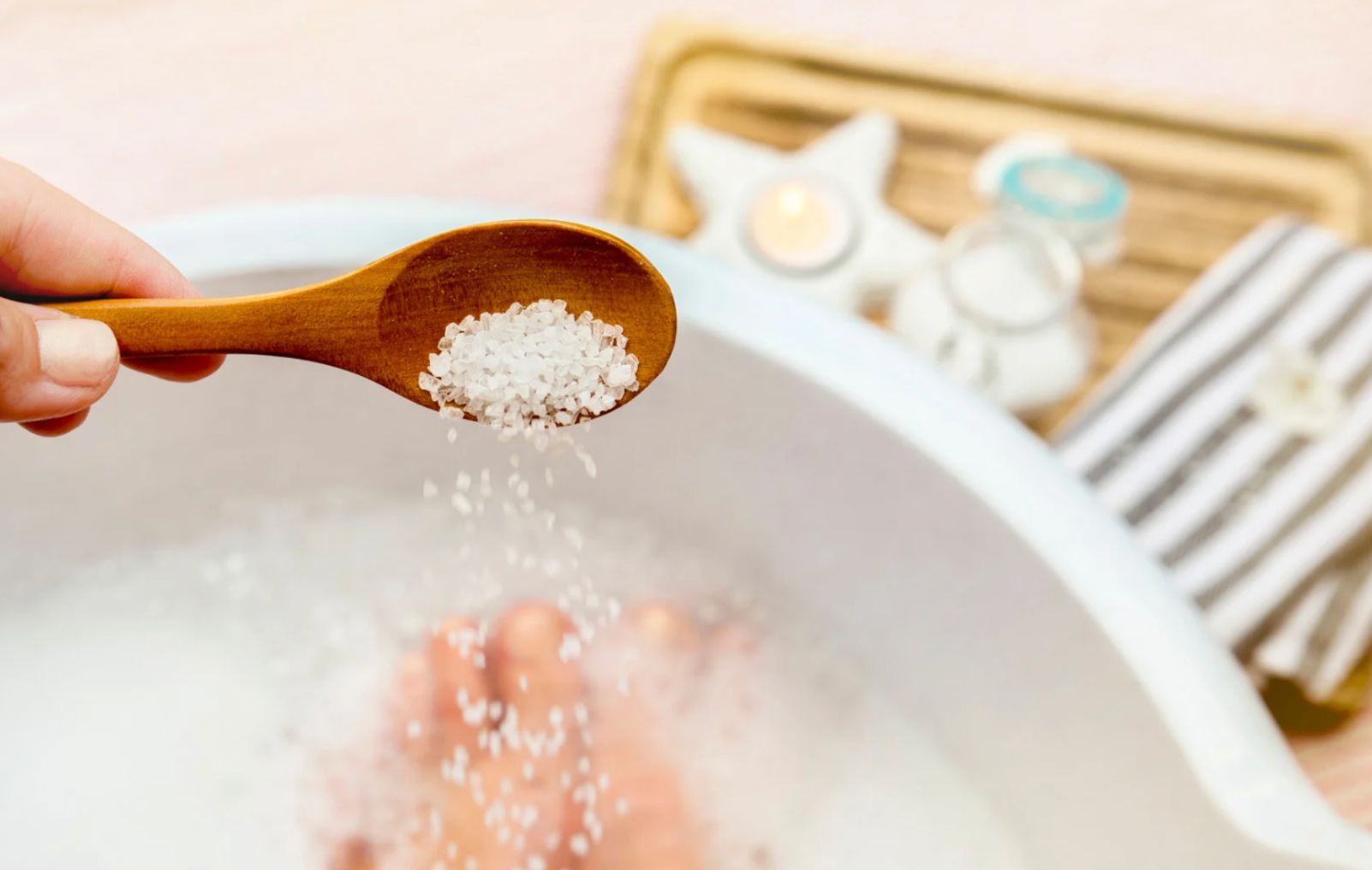 sprinkling salt soaks in bathtub with a wooden spoon