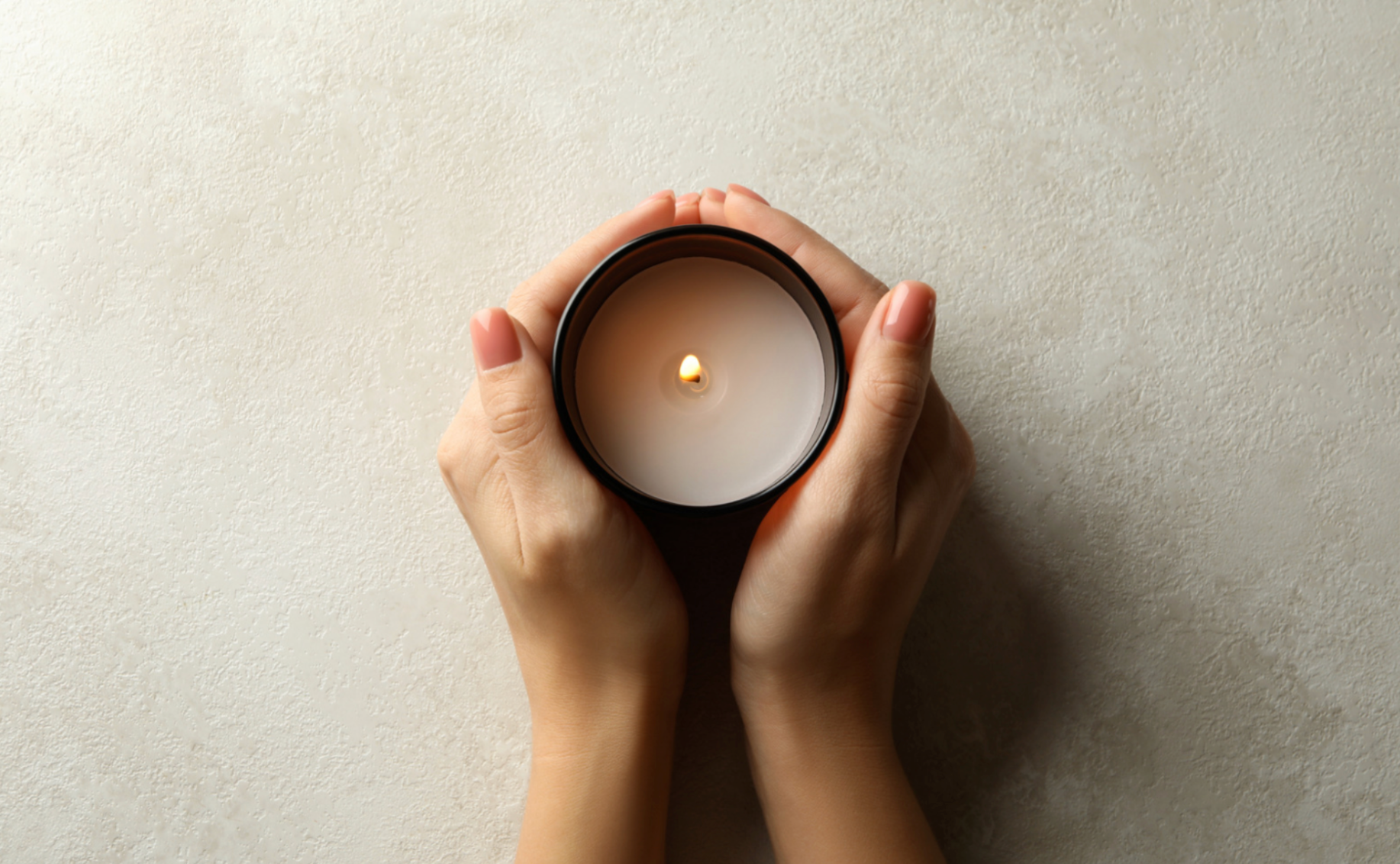 candle being held between hands