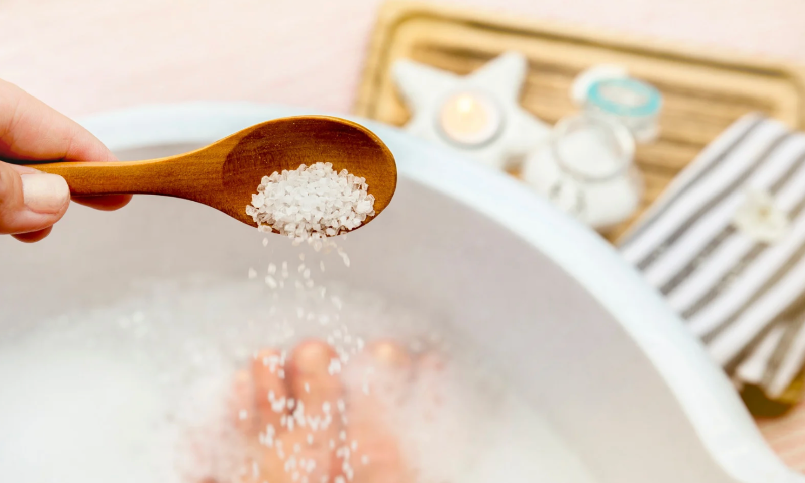sprinkling salt soaks in bathtub with a wooden spoon
